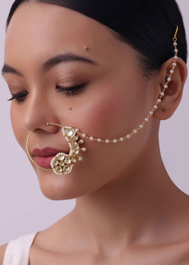 White Pearl Studded Nath In Gold Finish Mix Metal
